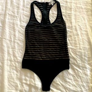 Black/Tan bodysuit with snap bottom closure, zipper back.